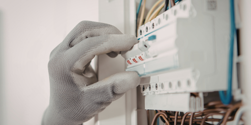 Hand holding a circuit breaker in place